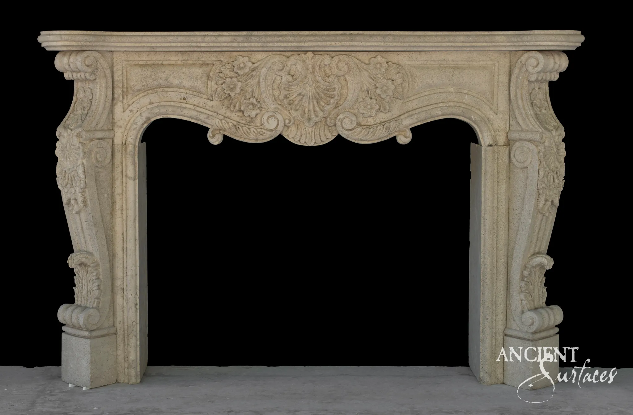 Reclaimed Louis XV antique limestone fireplace mantel from Ancient Surfaces with a carved floral cartouche and scrolled volute jambs