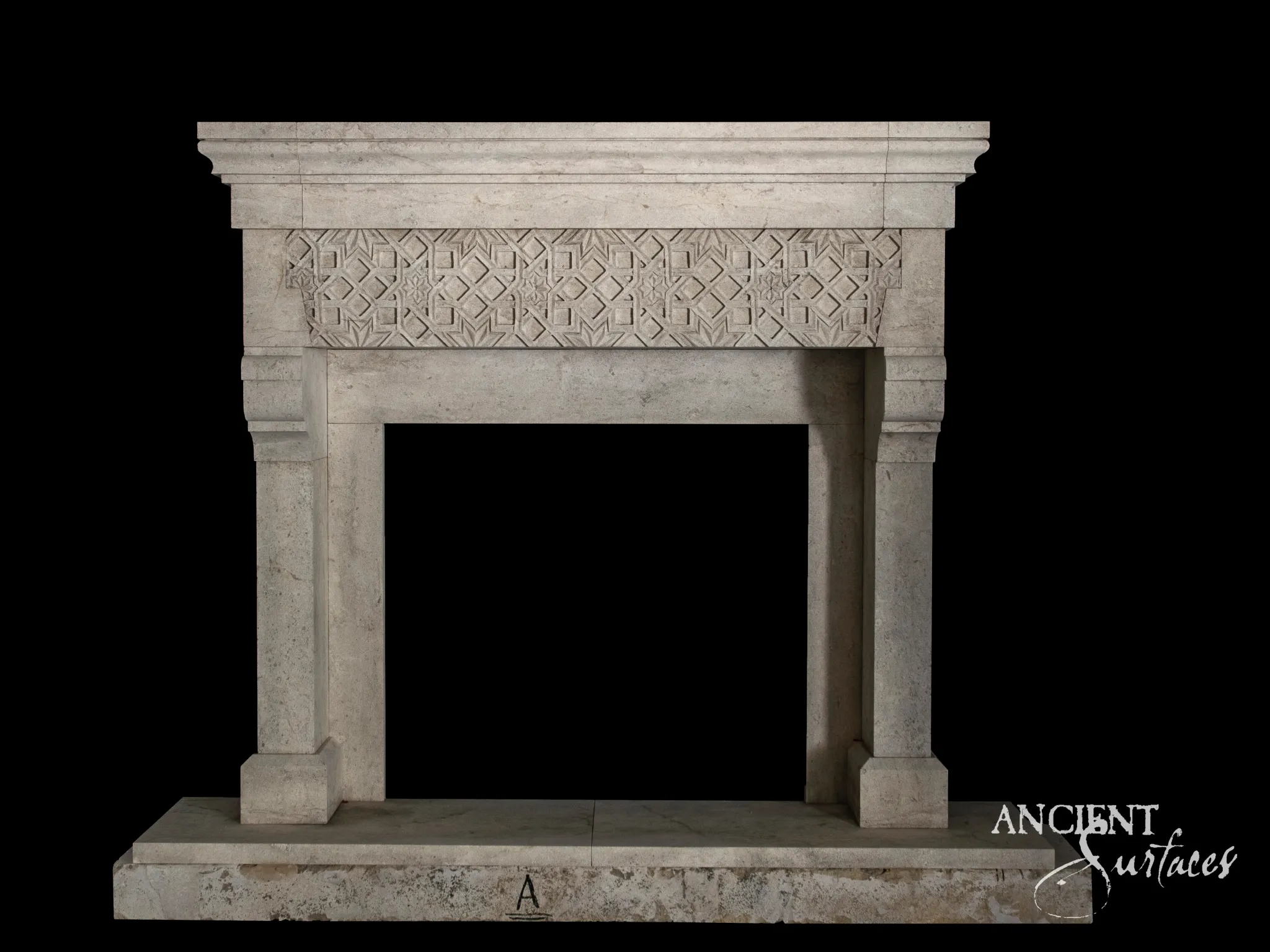 Wide reclaimed antique limestone fireplace mantel from Ancient Surfaces with a carved quatrefoil lattice frieze
